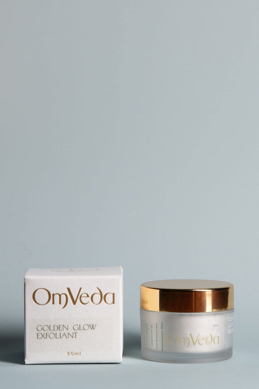 OmVeda Golden Glow exfoliant jar and carton, white container with gold lid