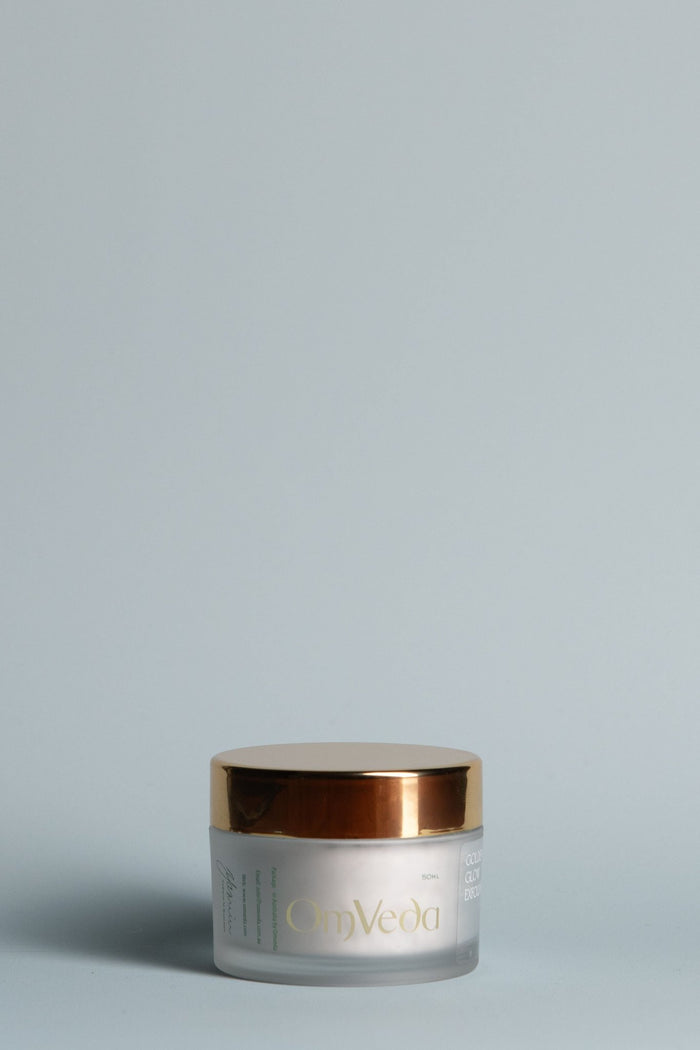 OmVeda Golden Glow exfoliant jar, white container with gold metal lid