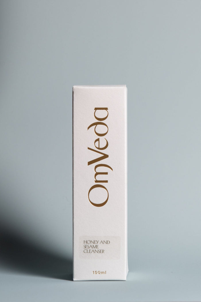 Honey and sesame cleanser retail box with OmVeda branding and gold accents, 150ml