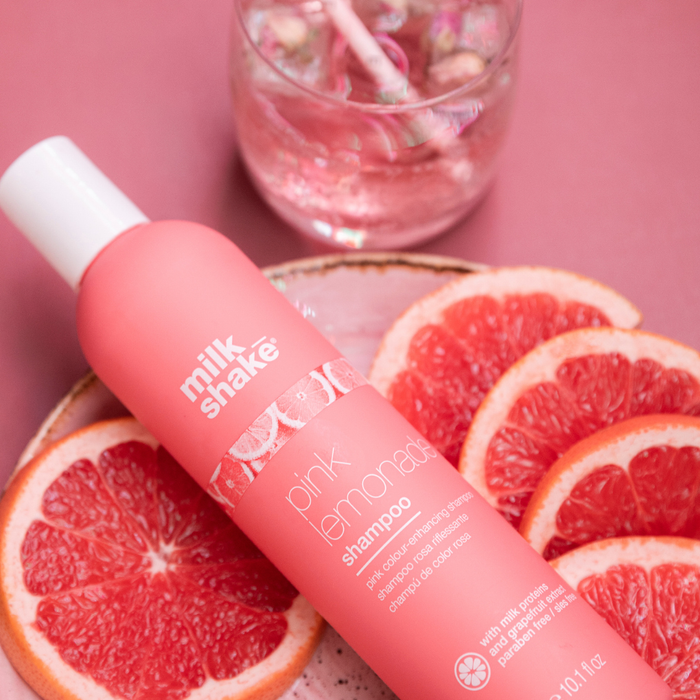 milk_shake Pink lemonade shampoo bottle with grapefruit slices on a pink background