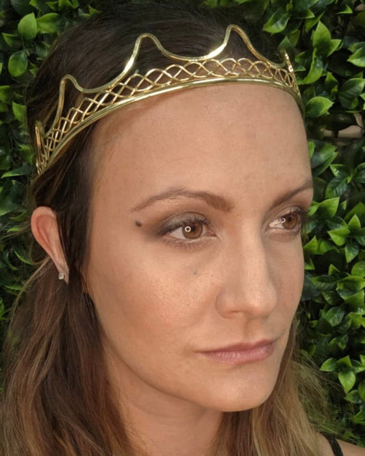 Model wearing Royal Crown gold wire regal headpiece, front three-quarter view.