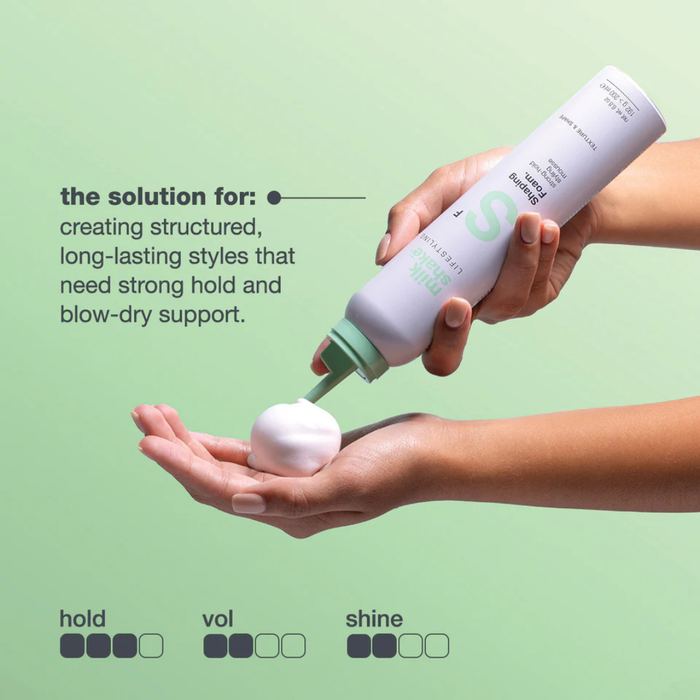 Hand holding a bottle of milk_shake  shaping foam with text on a green background