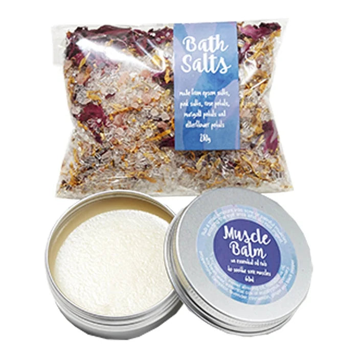 Bath salts and muscle rub in a tin with lid open.