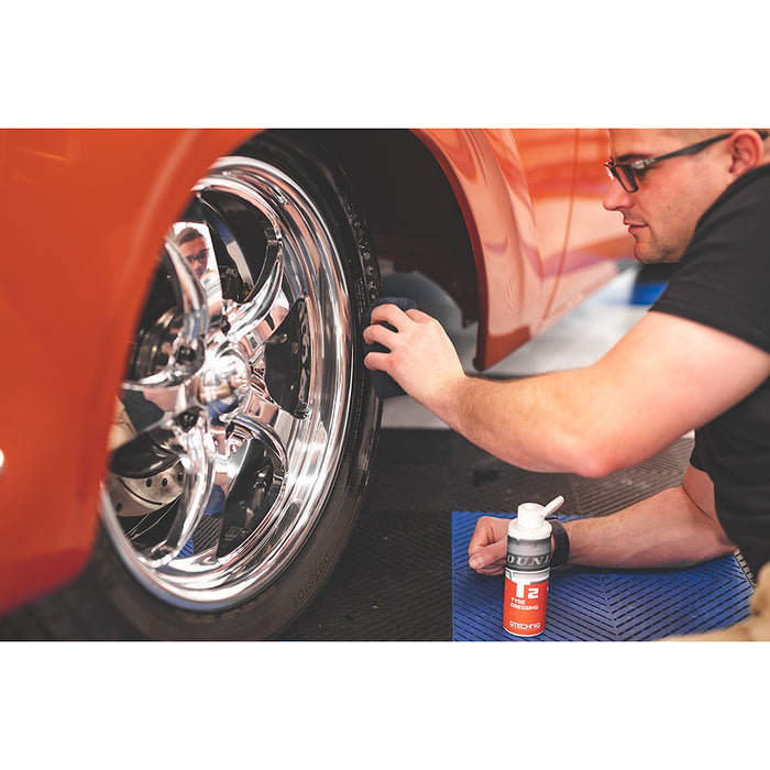 Terry Sponge black 3x5 applying product to tire.