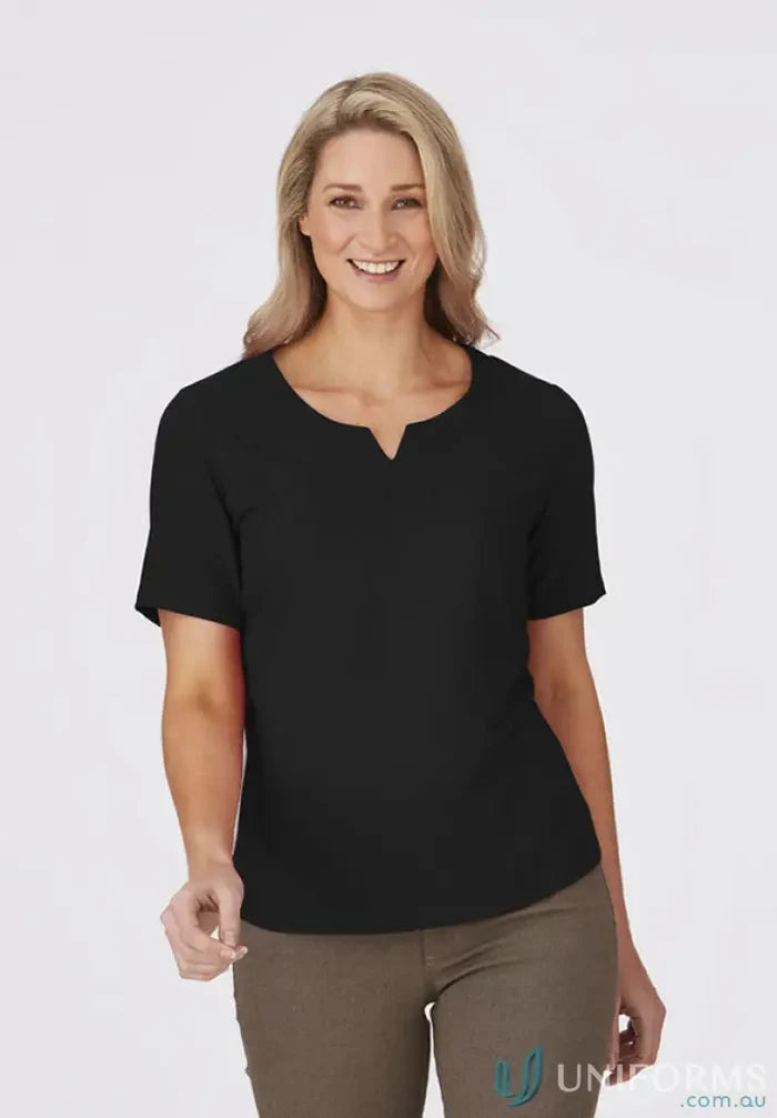 Woman in black top and khaki pants from City Collection Knit woven short sleeve knit collection