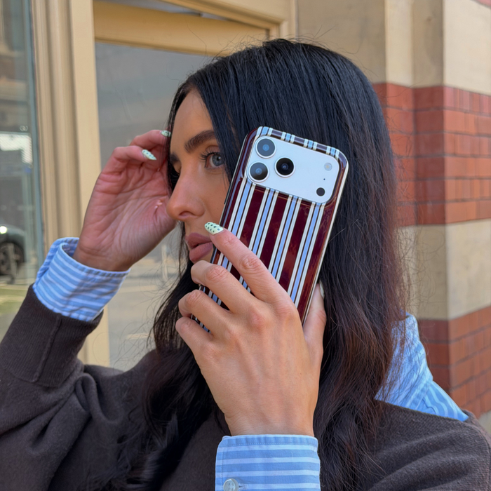 Girl on the phone with her case Tough Brown and Blue Stripe Phone Case wearing a matching outfit
