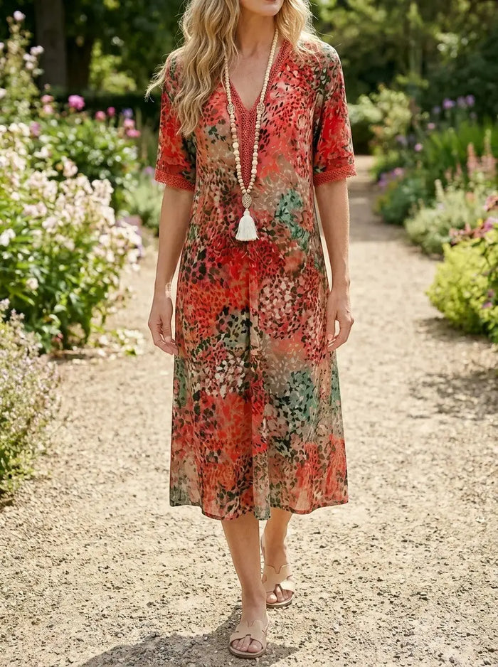 Women's all-over printed V-neck midi dress by LondonLaneStore featuring relaxed fit, short sleeves, and vibrant floral pattern.