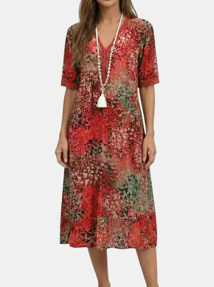 Women's printed V-neck midi dress by LondonLaneStore featuring a relaxed fit and short sleeves, with a vibrant all-over floral pattern.