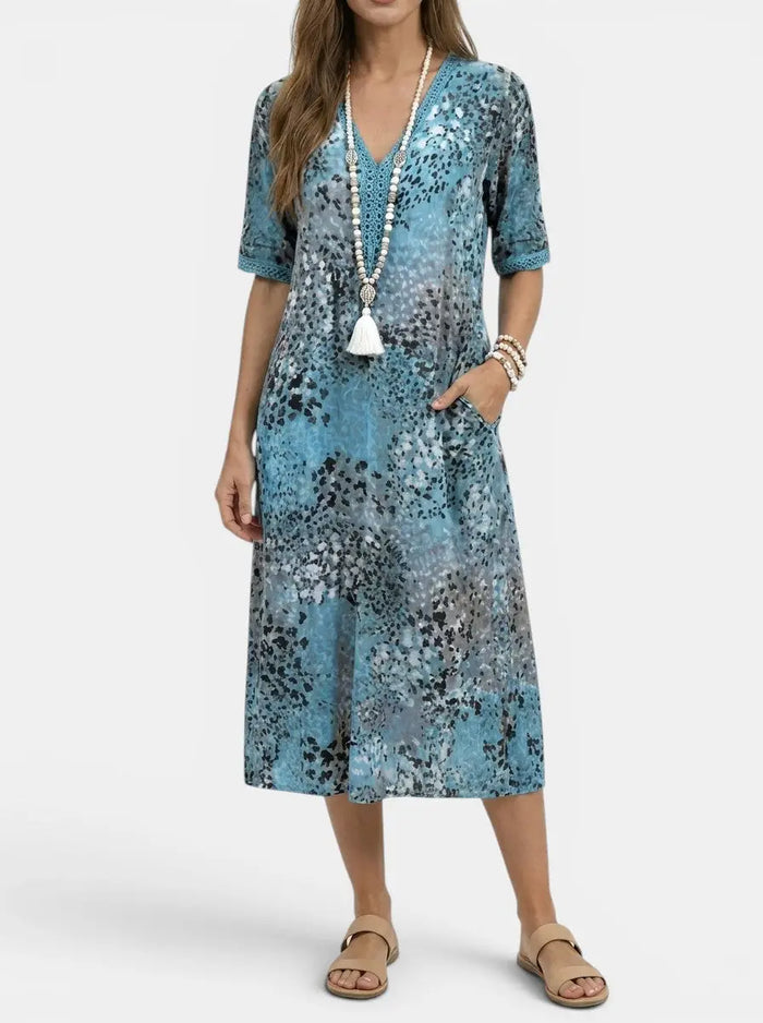 Women's all-over printed V-neck midi dress by LondonLaneStore featuring a relaxed fit, short sleeves, and vibrant floral pattern.
