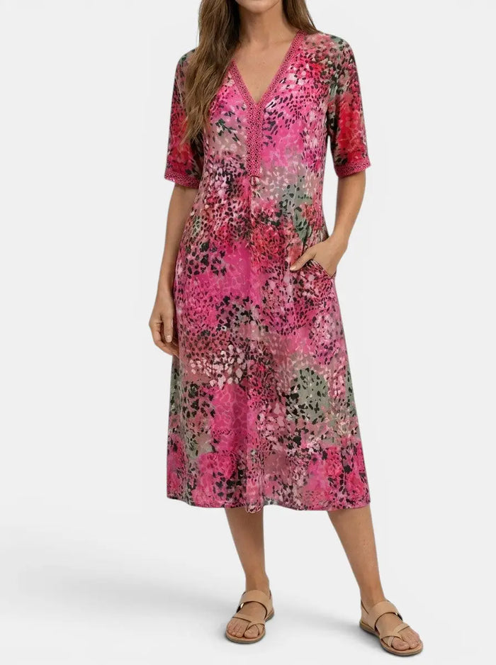 Women's all-over printed V-neck midi dress by LondonLaneStore featuring a relaxed fit and short sleeves.