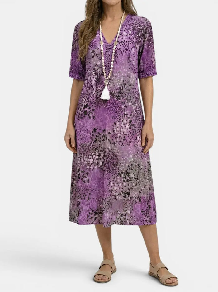 Women's printed V-neck midi dress by LondonLaneStore with relaxed fit, short sleeves, and colorful all-over floral pattern.