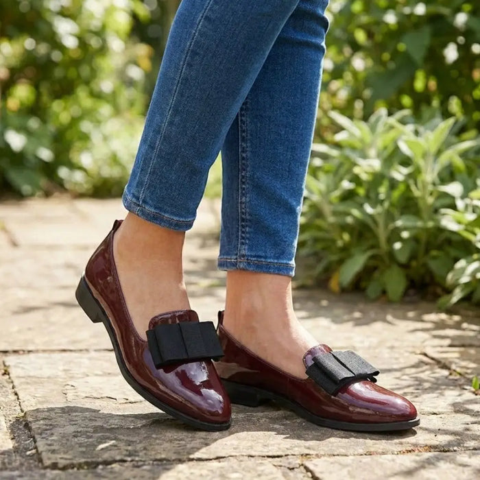Women's black patent leather loafers with pointed toes and slip-on design, stylish and elegant footwear by LondonLaneStore.