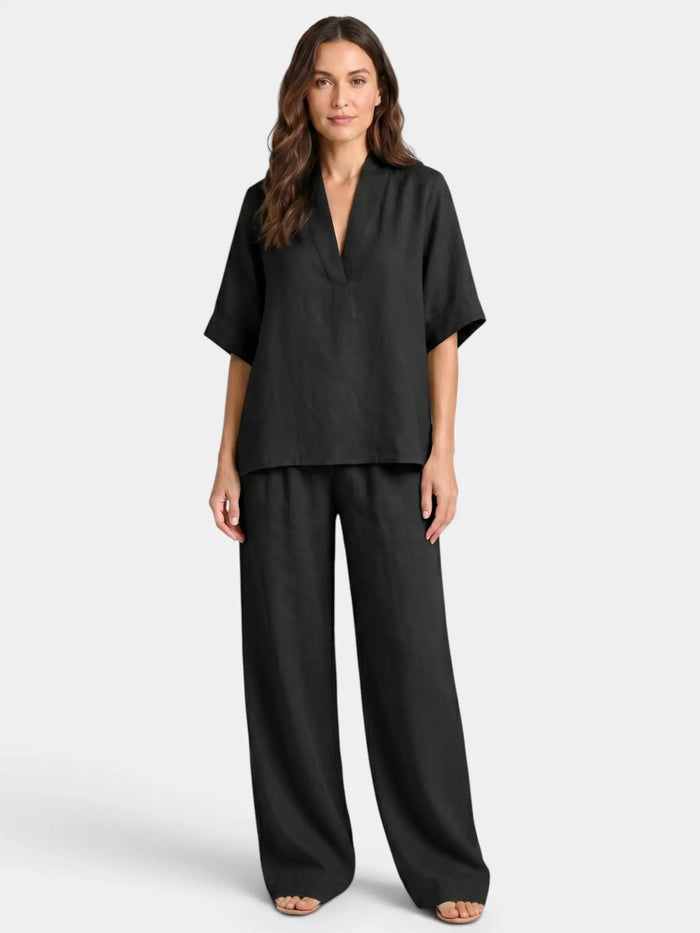 Women's breathable linen co-ord set with relaxed V-neck top and wide-leg trousers, styled for comfort and casual elegance.