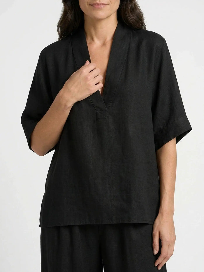 Elegant women's linen loungewear set with V-neck top and flowing trousers, lightweight and breathable, perfect for relaxed comfort.
