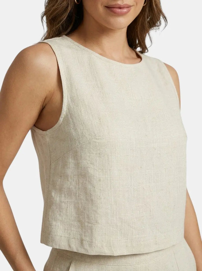 Women's breathable linen summer suit featuring a tailored crop top and structured shorts, perfect for warm weather.