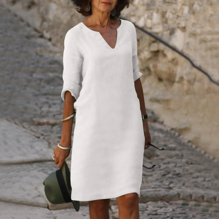 Women's V-neck midi dress with 3/4 sleeves, casual elegant style, from LondonLaneStore, shown on a model.
