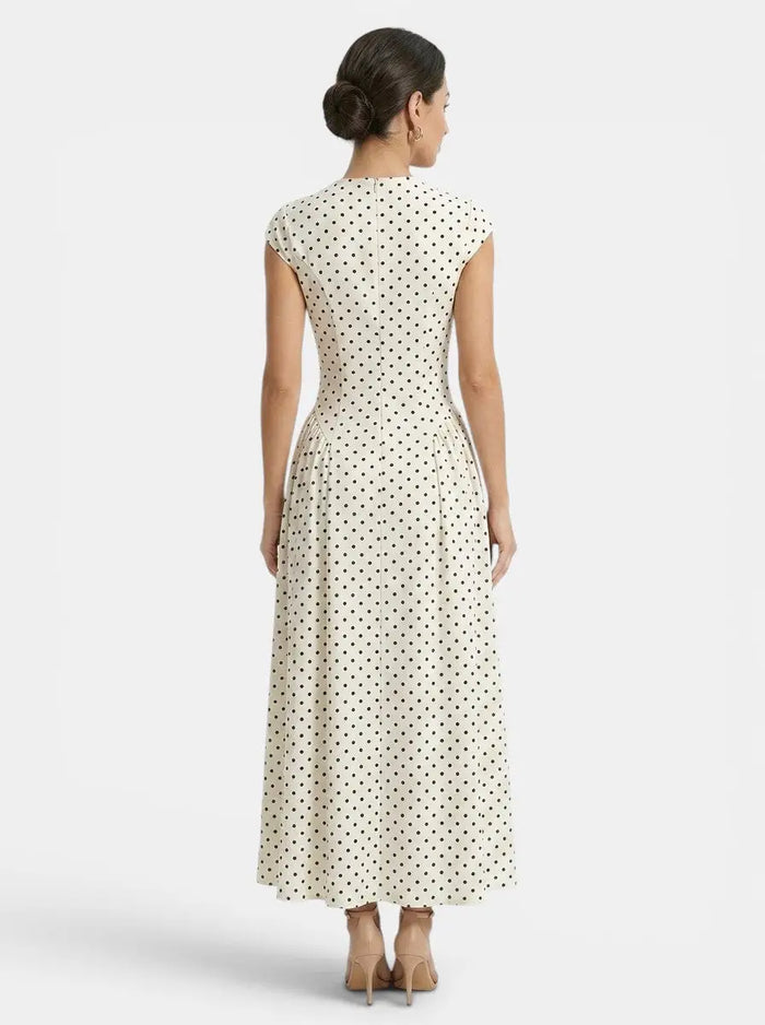 Women's elegant polka dot maxi dress with cap sleeves and A-line silhouette, perfect for summer occasions.