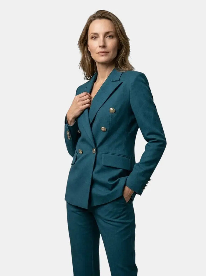 Women's elegant white tailored suit featuring a double-breasted blazer and flared trousers, perfect for sophisticated office wear.