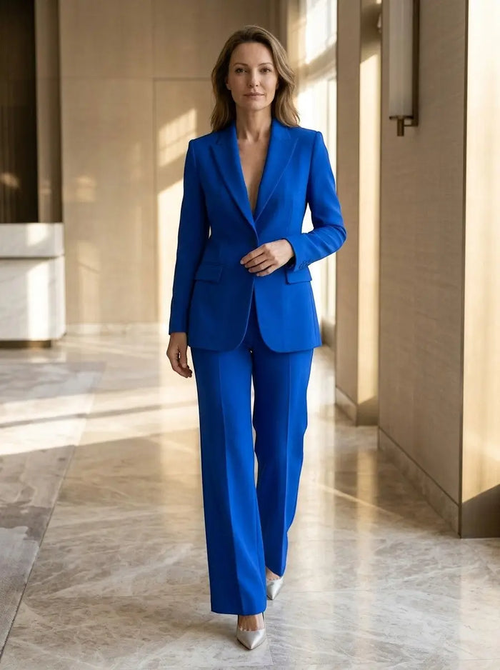 Women's white tailored blazer suit with longline blazer and wide-leg trousers, stylish and elegant for professional wear.