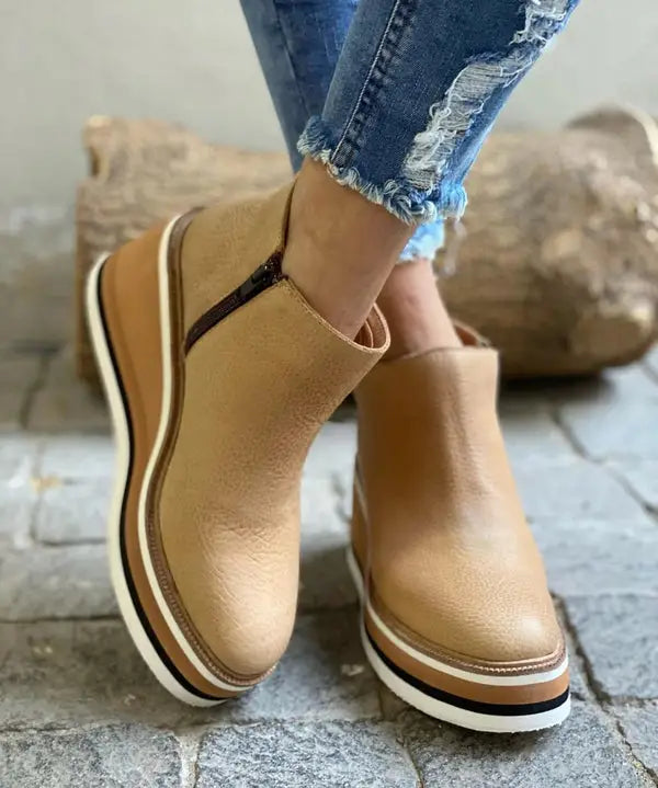 Elegant waterproof women's boots with stylish orthopedic design, suitable for autumn and winter weather.