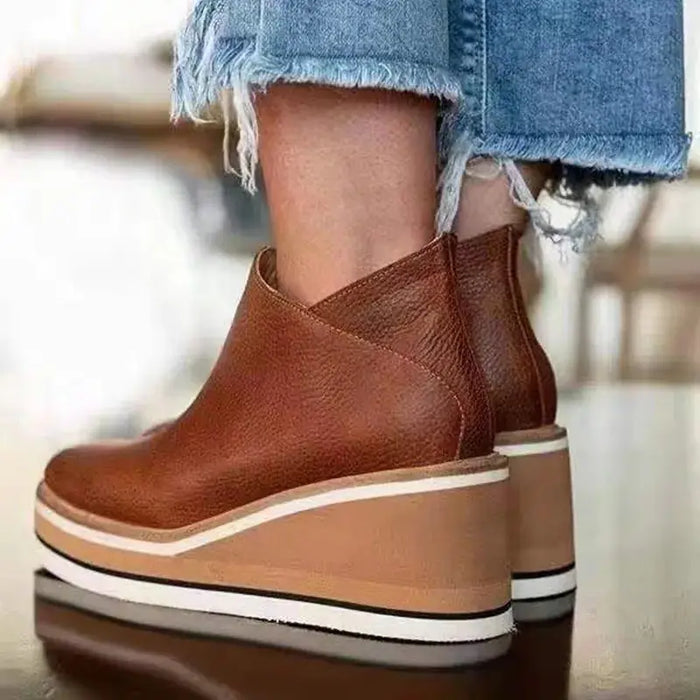 Women’s elegant waterproof boots with stylish orthopedic design, suitable for autumn and winter, shown in natural outdoor setting