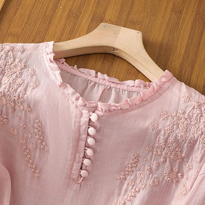 Elegant white embroidered cotton blouse for women with a classic button-front design, perfect as a summer top.