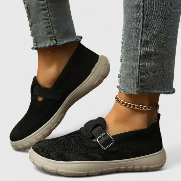 Women's black leather orthopedic loafers with slip-on design and arch support, featuring ergonomic comfort and stylish look.