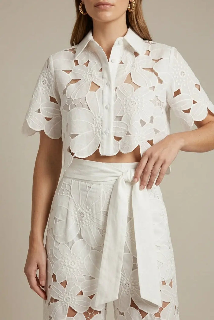 Women's floral lace two-piece set featuring an elegant cape overlay top and wide-leg trousers, stylish and sophisticated.