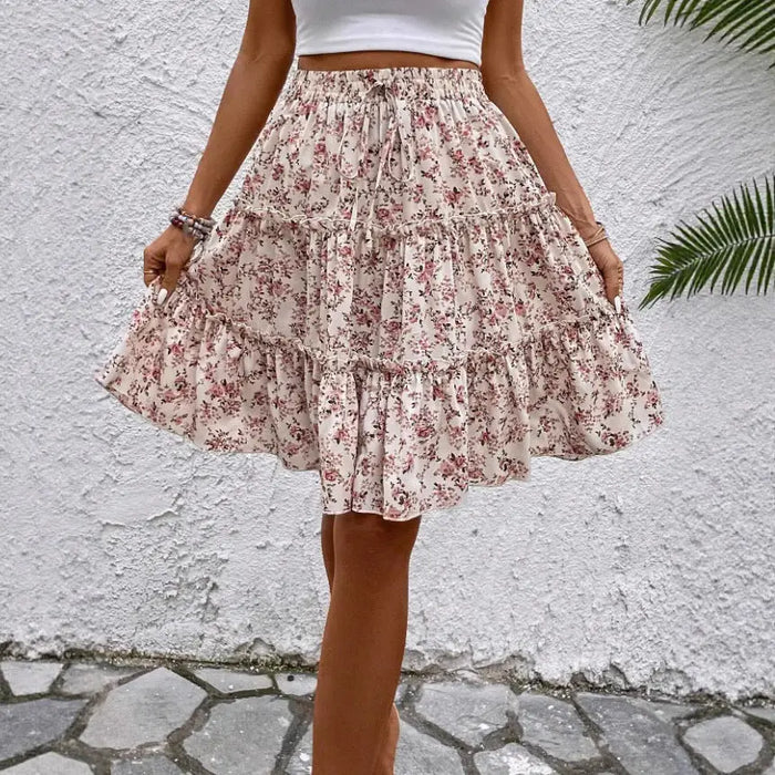 Floral print women's midi skirt with relaxed fit, flared design, and ruffled hem, perfect for summer wear.