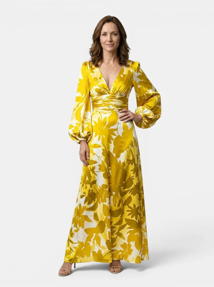 Women's flowing fabric maxi dress with elegant defined waist and long sleeves, perfect for summer occasions.