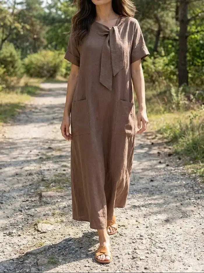Women’s flowy summer dress by LondonLaneStore featuring an elegant neck tie design and practical pockets, perfect for warm weather.