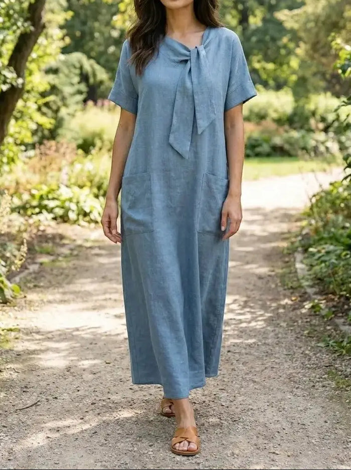 Women's flowy fabric summer dress by LondonLaneStore with chic neck tie, pockets, and elegant design perfect for warm weather.