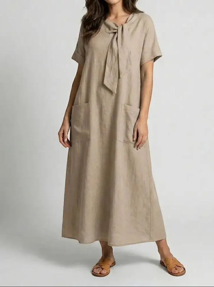Women's flowy summer dress by LondonLaneStore featuring chic neck tie, elegant design, and convenient pockets.
