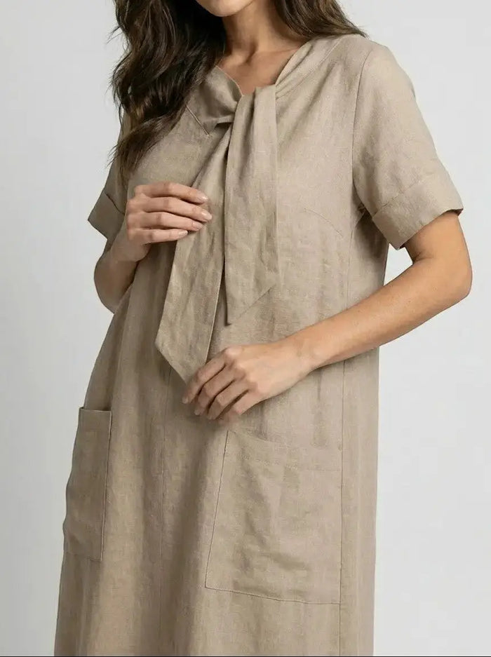 Women’s flowy fabric summer dress by LondonLaneStore with chic neck tie, elegant style, and functional pockets.