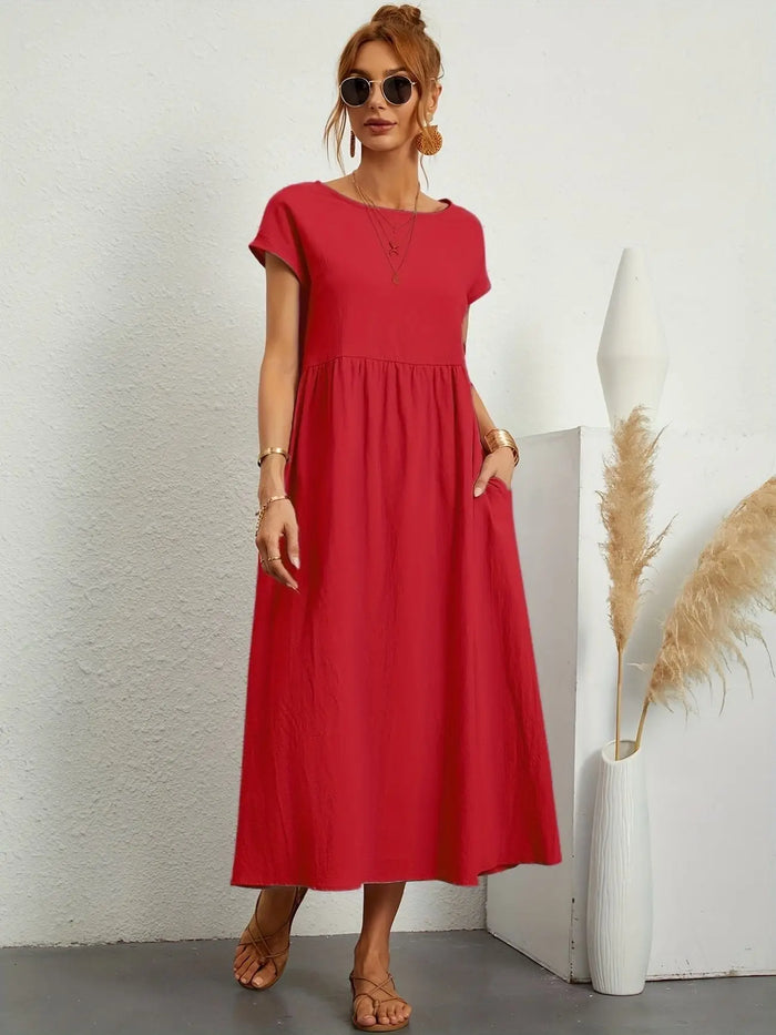 Woman wearing a lightweight cotton summer dress by LondonLaneStore featuring an elegant relaxed fit and refined neckline.