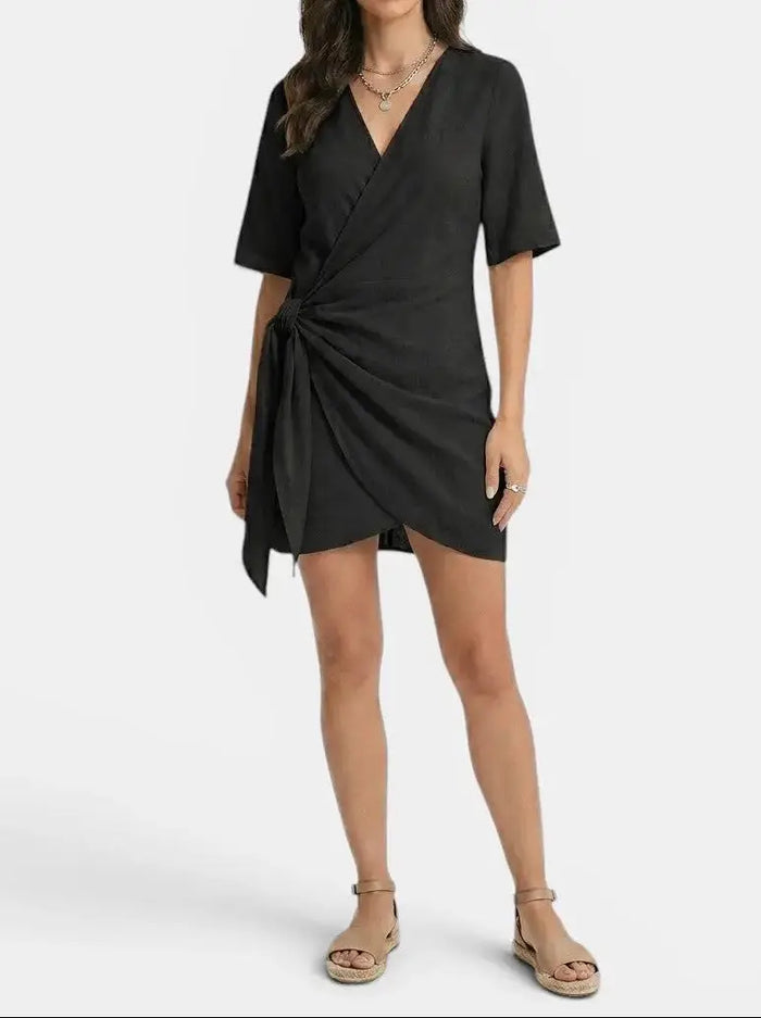 Women's linen blend wrap mini dress with elegant asymmetrical hem, perfect for summer fashion, from LondonLaneStore.