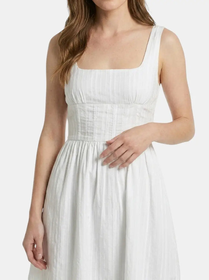 Women's organic cotton white mini summer dress with elegant square neck and ruffle details, perfect for warm weather.