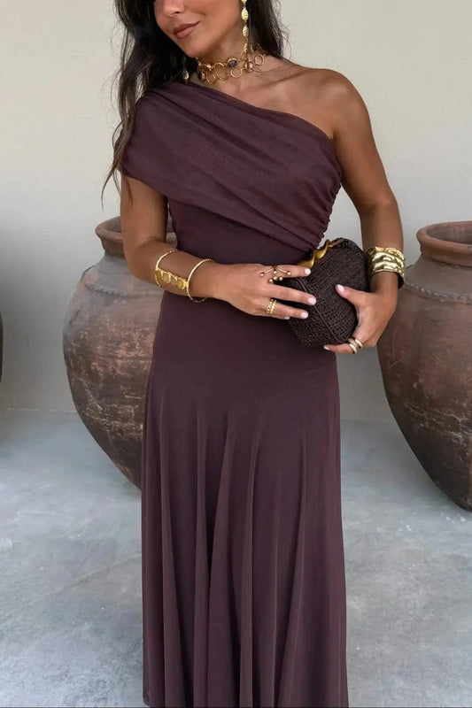 Women’s pleated polyester maxi dress with flowing asymmetrical design, perfect for summer or evening occasions.