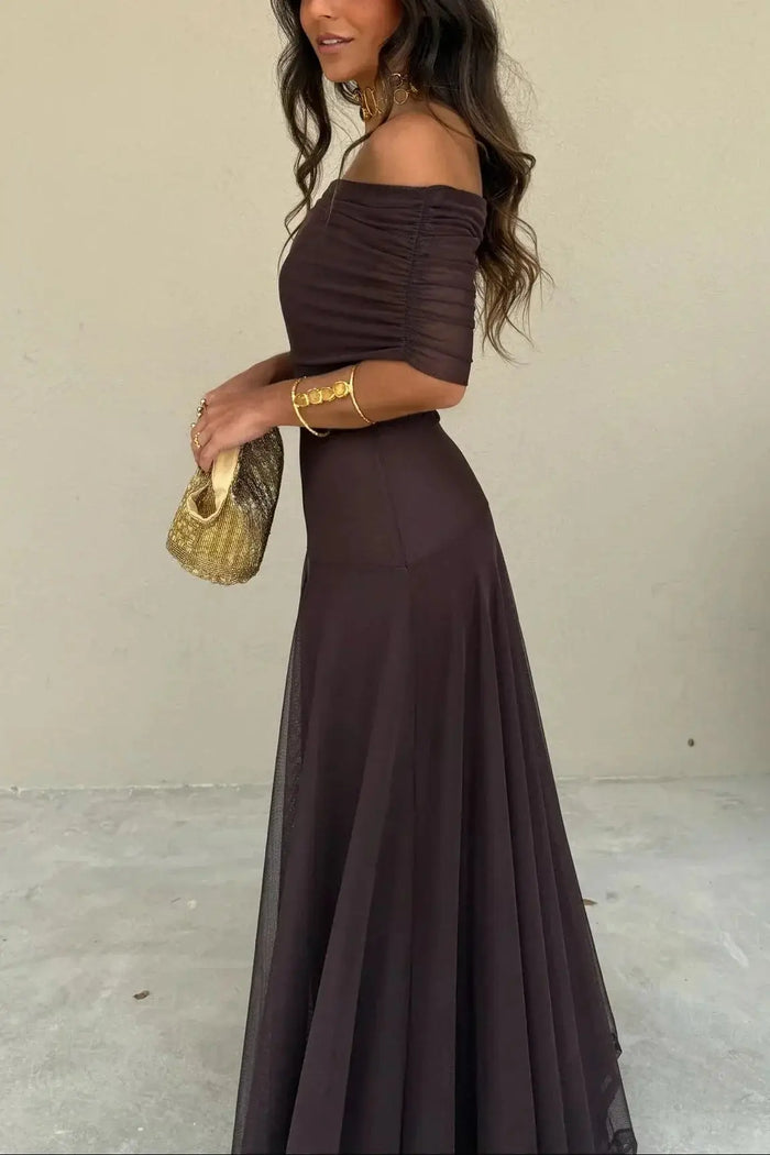 Women's pleated polyester maxi dress with flowing asymmetrical hem, perfect for summer evening occasions.