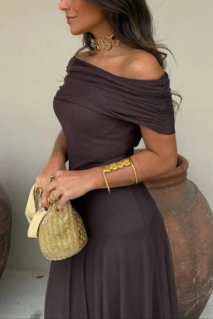 Women’s pleated polyester maxi dress with flowing asymmetrical hem, perfect for summer evening occasions.