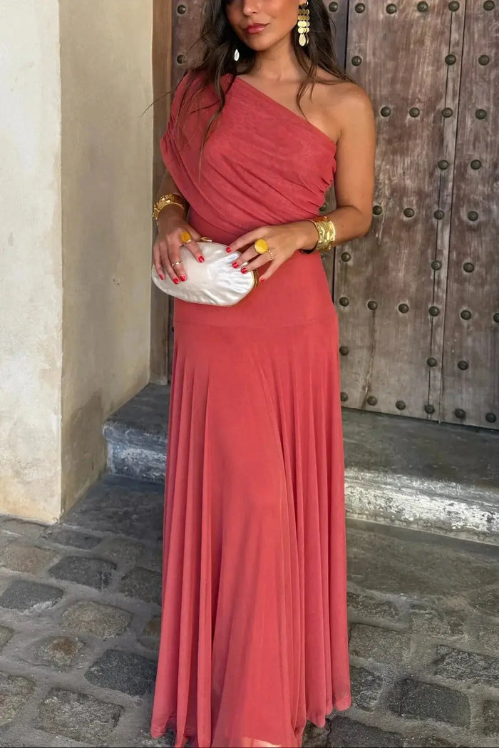 Women's pleated polyester maxi dress with flowing asymmetrical hem, perfect for summer evening wear.