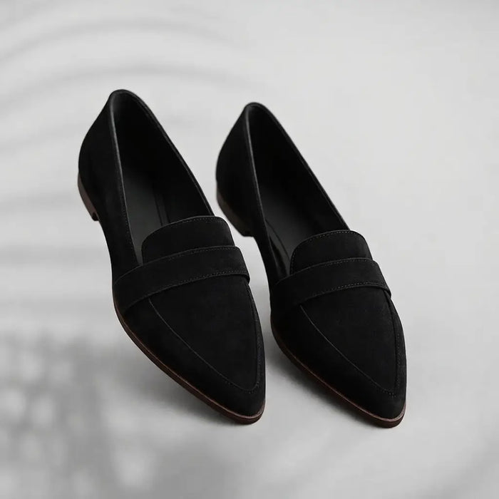Women's polished leather loafers with sleek toe design, slip-on style, ideal for elegant casual or office wear.