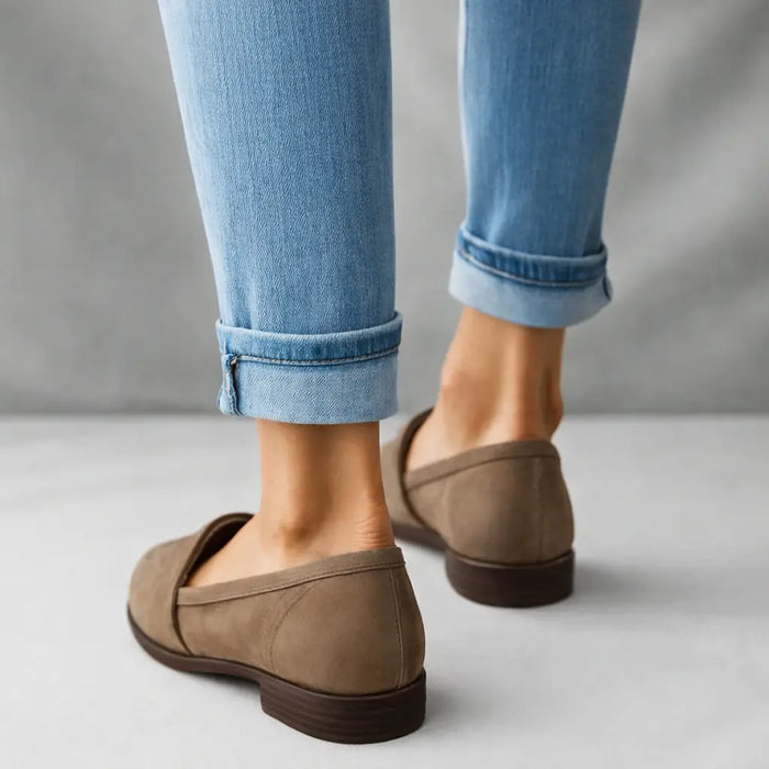 Women's polished leather loafers with sleek toe design, slip-on style, perfect for elegant and comfortable footwear.