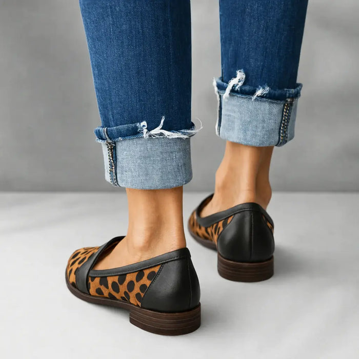Women's polished leather loafers with sleek toe design, slip-on style, perfect for elegant casual or professional wear.