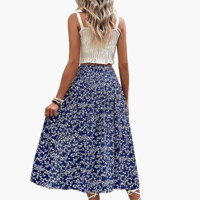 Women's printed woven midi skirt with stylish A-line design and side slit, featuring vibrant pattern and flowy fabric.