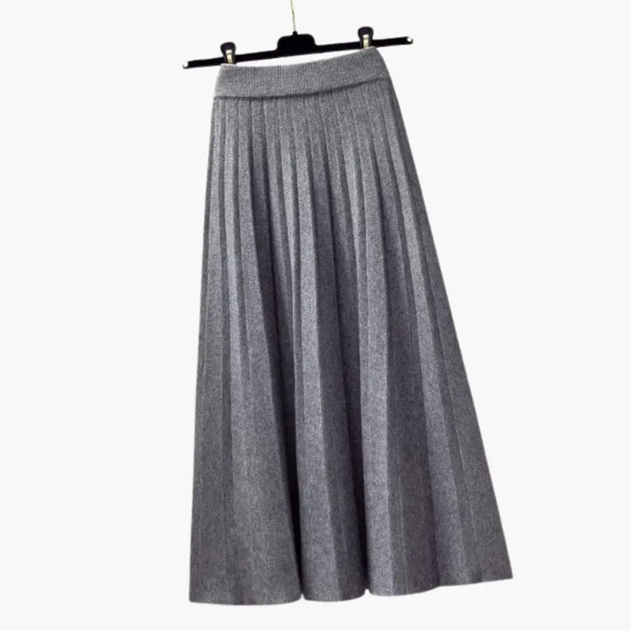 Women's ribbed knit pleated maxi skirt with flowing ankle-length design and elegant textured fabric, perfect for stylish comfort.
