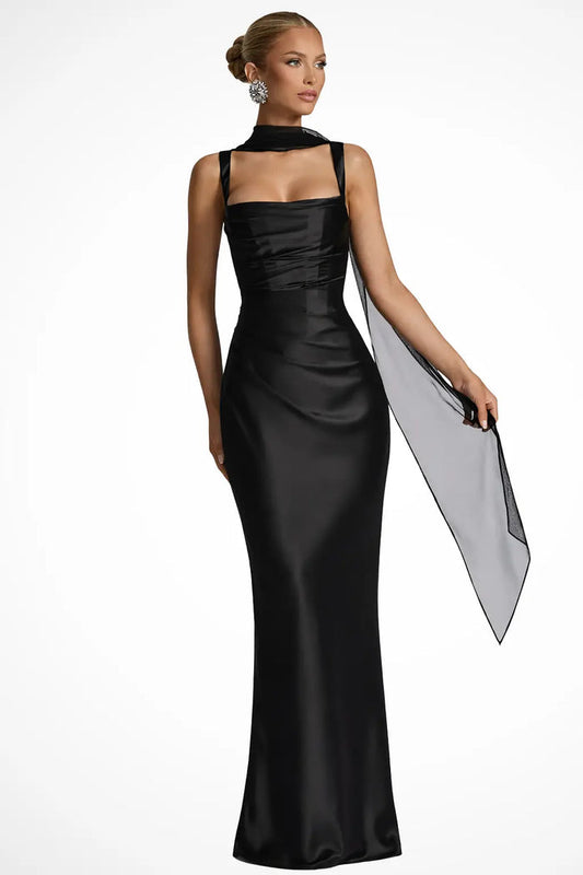 Woman wearing a satin maxi dress with a structured square neckline and ruched design by LondonLaneStore.