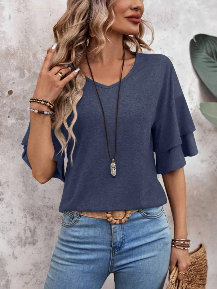 Women’s sheer white blouse with elegant half sleeves, stylish summer top from LondonLaneStore, displayed on a model.