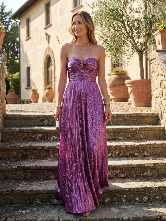 Women's shiny fabric maxi dress with a strapless design and pleated details, perfect for elegant evening occasions.