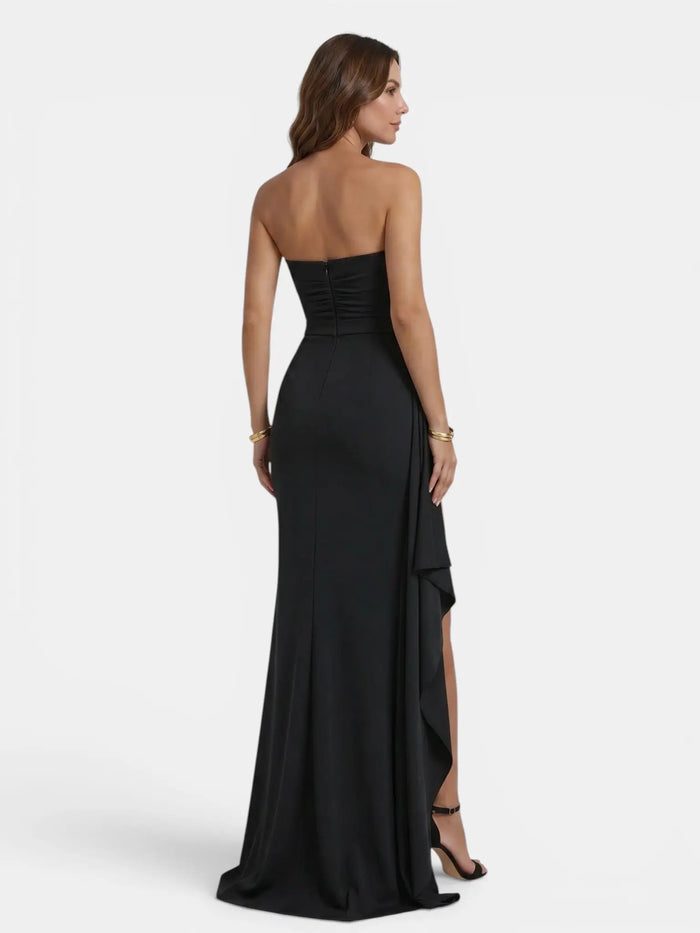 Women's smooth fabric strapless maxi dress with dramatic side slit, showcasing elegant design and flowing silhouette.
